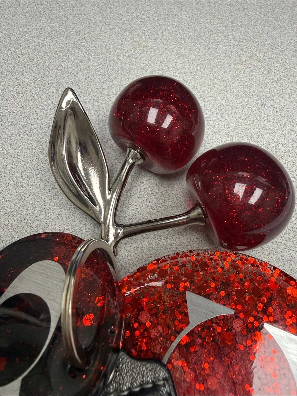 COACH Gunmetal Leather Tag with Red Glitter Cherry Keyring
